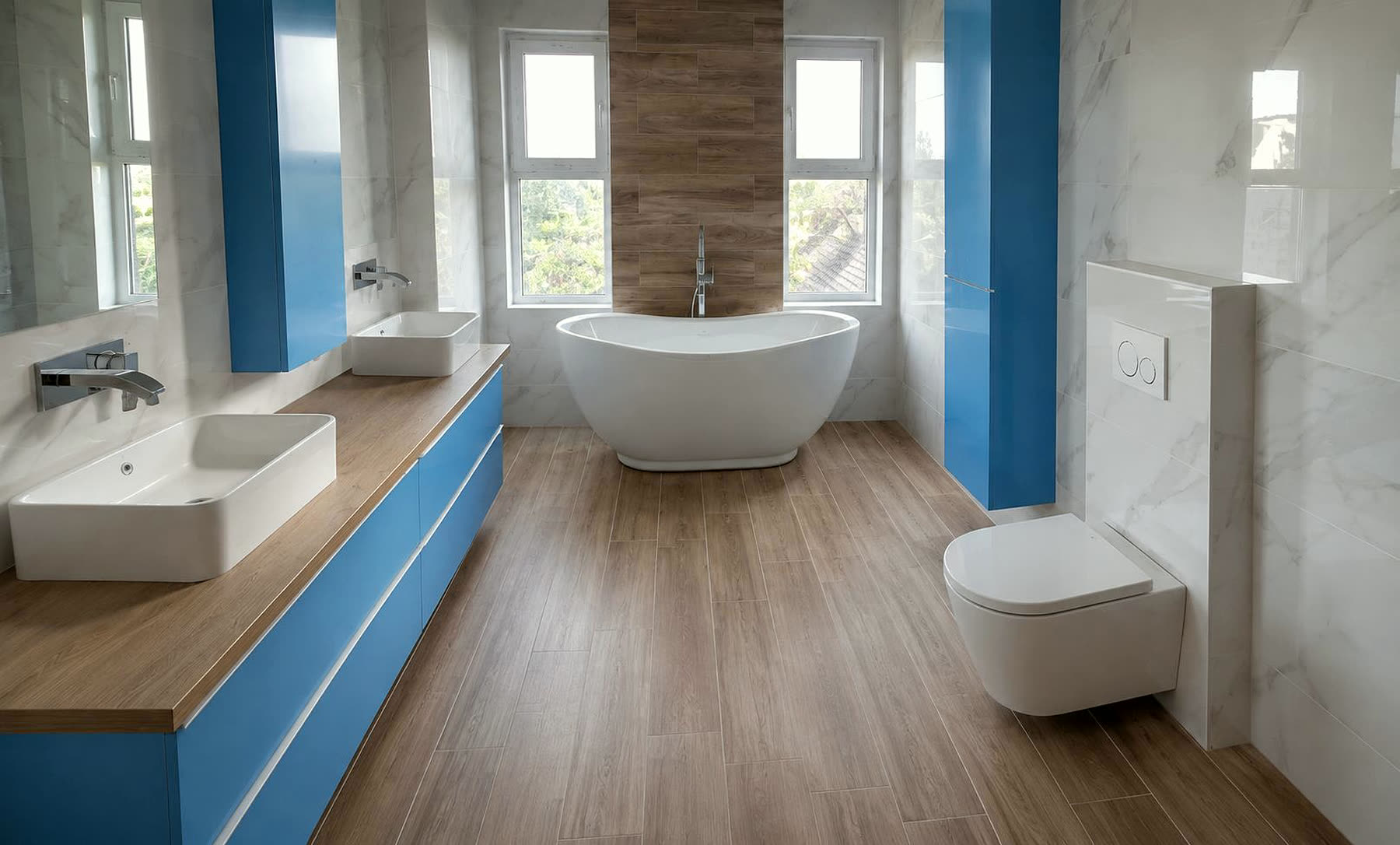 Salle de bain rénovée par Sani-Chauffe : baignoire îlot, double vasque, grès effet marbre et parquet céramique